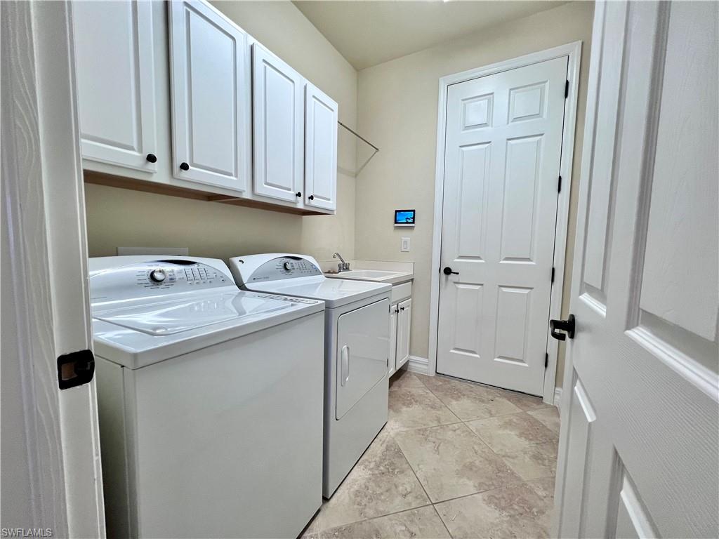 9419 Piacere Way Naples, FL 34113 - Photo 16 of 19 a utility room with a sink a cabinetry and a window