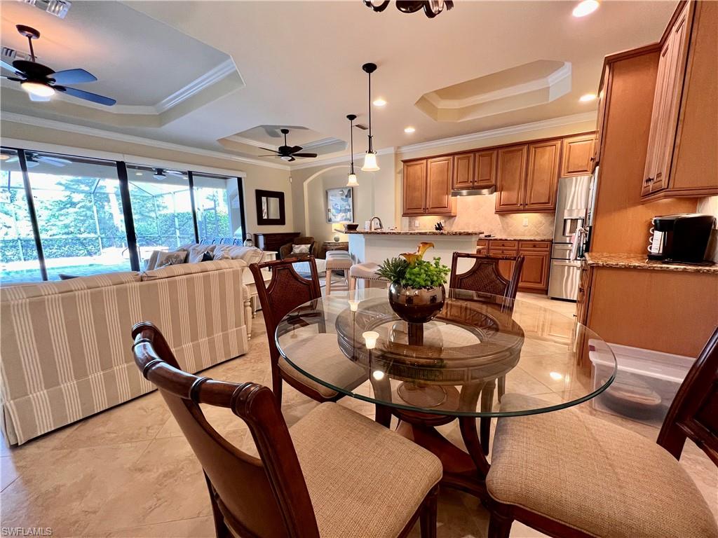 9419 Piacere Way Naples, FL 34113 - Photo 7 of 19 a view of a dining room with furniture window and outside view
