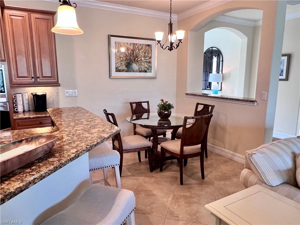 9419 Piacere Way Naples, FL 34113 - Photo 8 of 19 a view of a dining room with furniture