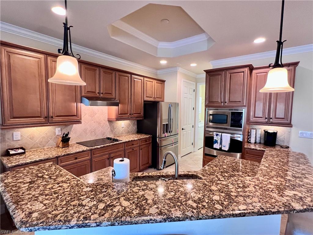 9419 Piacere Way Naples, FL 34113 - Photo 9 of 19 a kitchen with stainless steel appliances granite countertop a refrigerator stove top oven a sink and dishwasher
