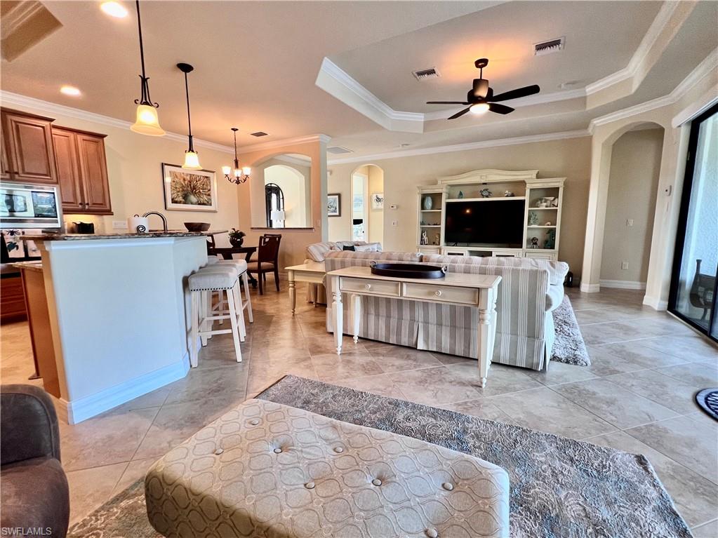 9419 Piacere Way Naples, FL 34113 - Photo 10 of 19 a living room with furniture and a flat screen tv