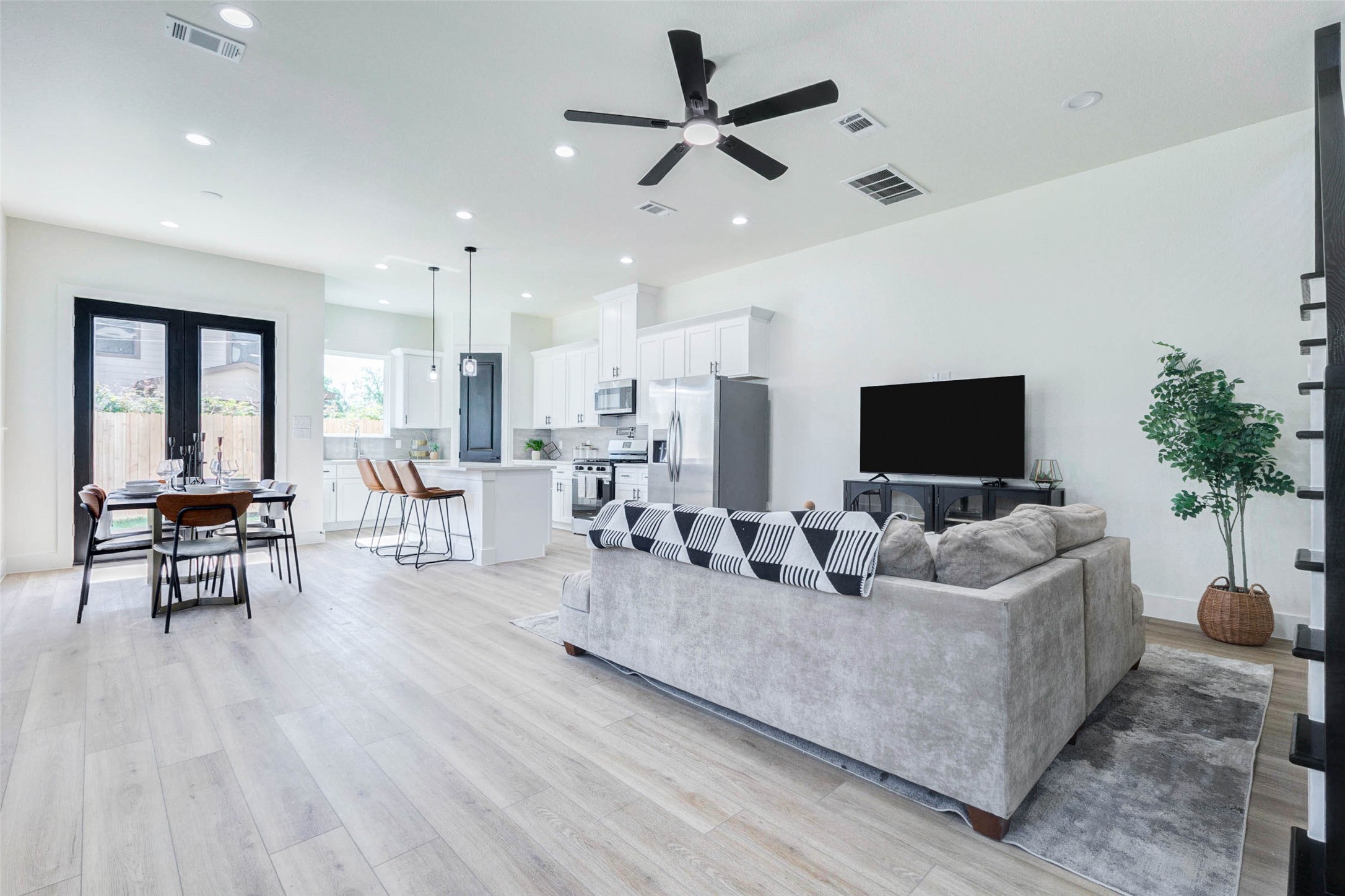 7115 England Street, Unit C Houston, TX 77021 - Photo 13 of 19 An open-concept layout seamlessly connects the spacious living area to the kitchen, featuring recessed lighting and durable wood-look flooring.