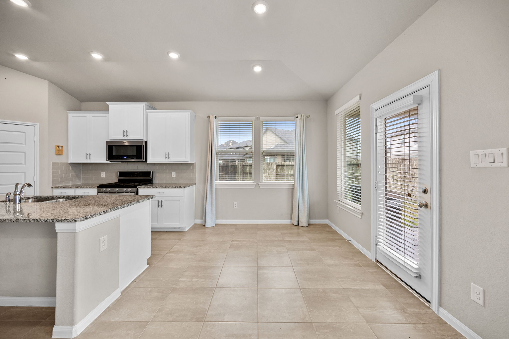 2406 Temple Crag Drive Rosharon, TX 77583 - Photo 12 of 26 The breakfast area is spacious and can easily accommodate a large table and seating. The space is surrounded by windows with views of the patio and backyard.