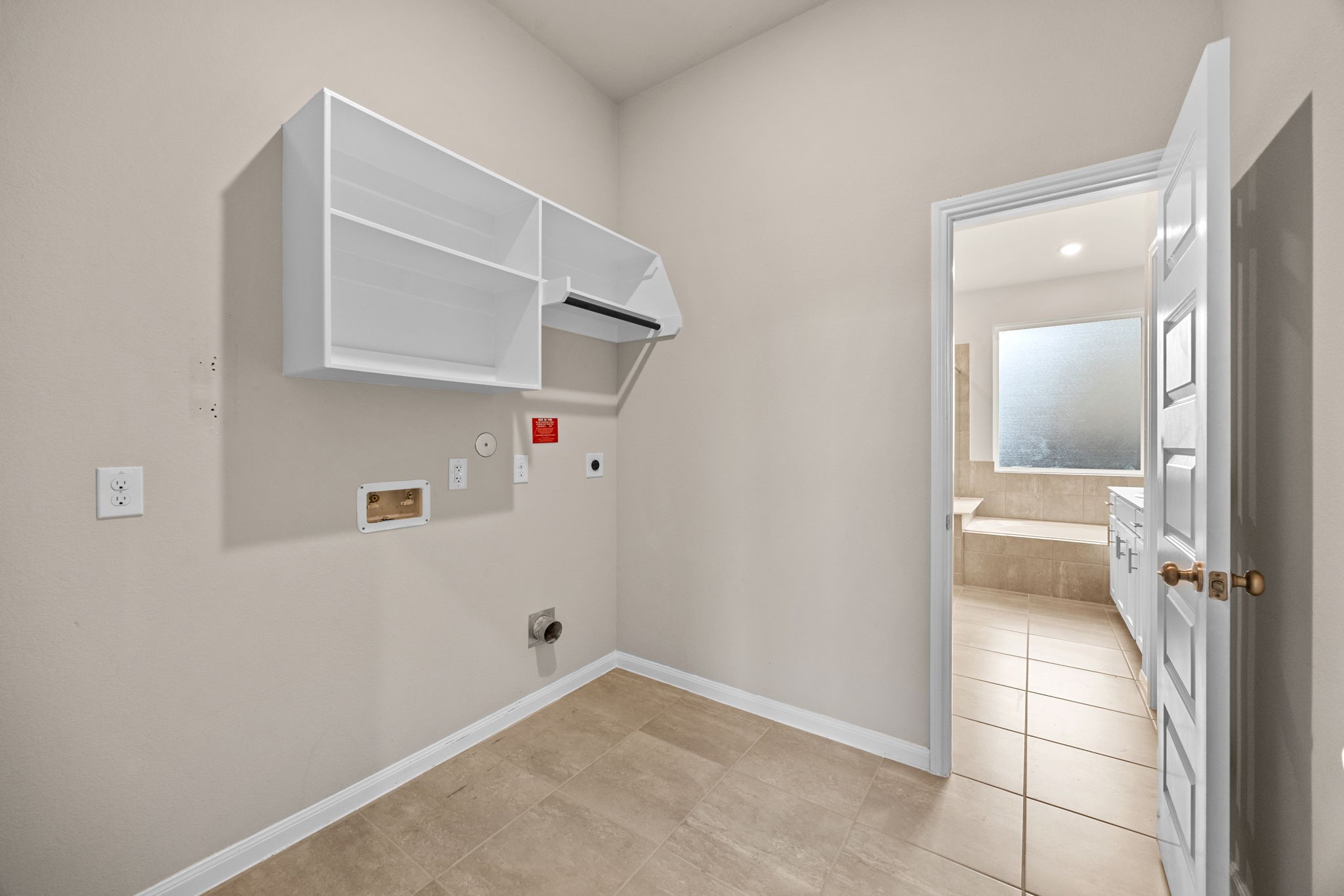 2406 Temple Crag Drive Rosharon, TX 77583 - Photo 17 of 26 The laundry room is conveniently placed between the primary bedroom's ensuite bath and between the secondary bedrooms and offers direct access to both rooms. No need to walk across the home to clean clothes!