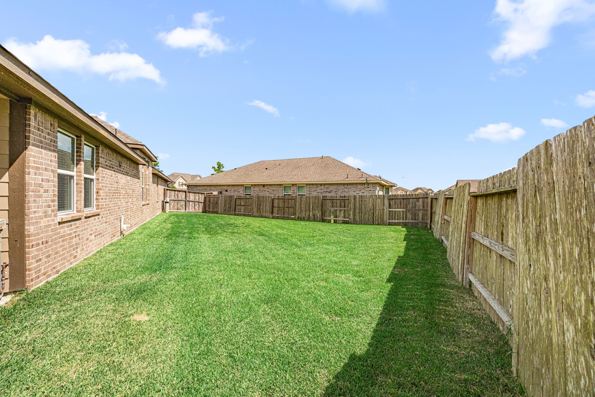 2406 Temple Crag Drive Rosharon, TX 77583 - Photo 25 of 26 The backyard greenspace is huge and is perfect for a child's playscape, adult games and putting your green thumb to work.