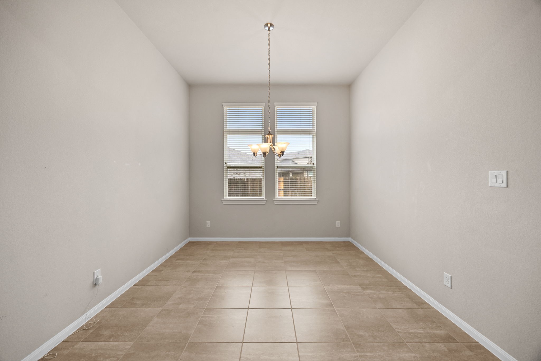 2406 Temple Crag Drive Rosharon, TX 77583 - Photo 5 of 26 The dining room is spacious with a pretty chandelier and double windows that allow soft natural light to flood the space.