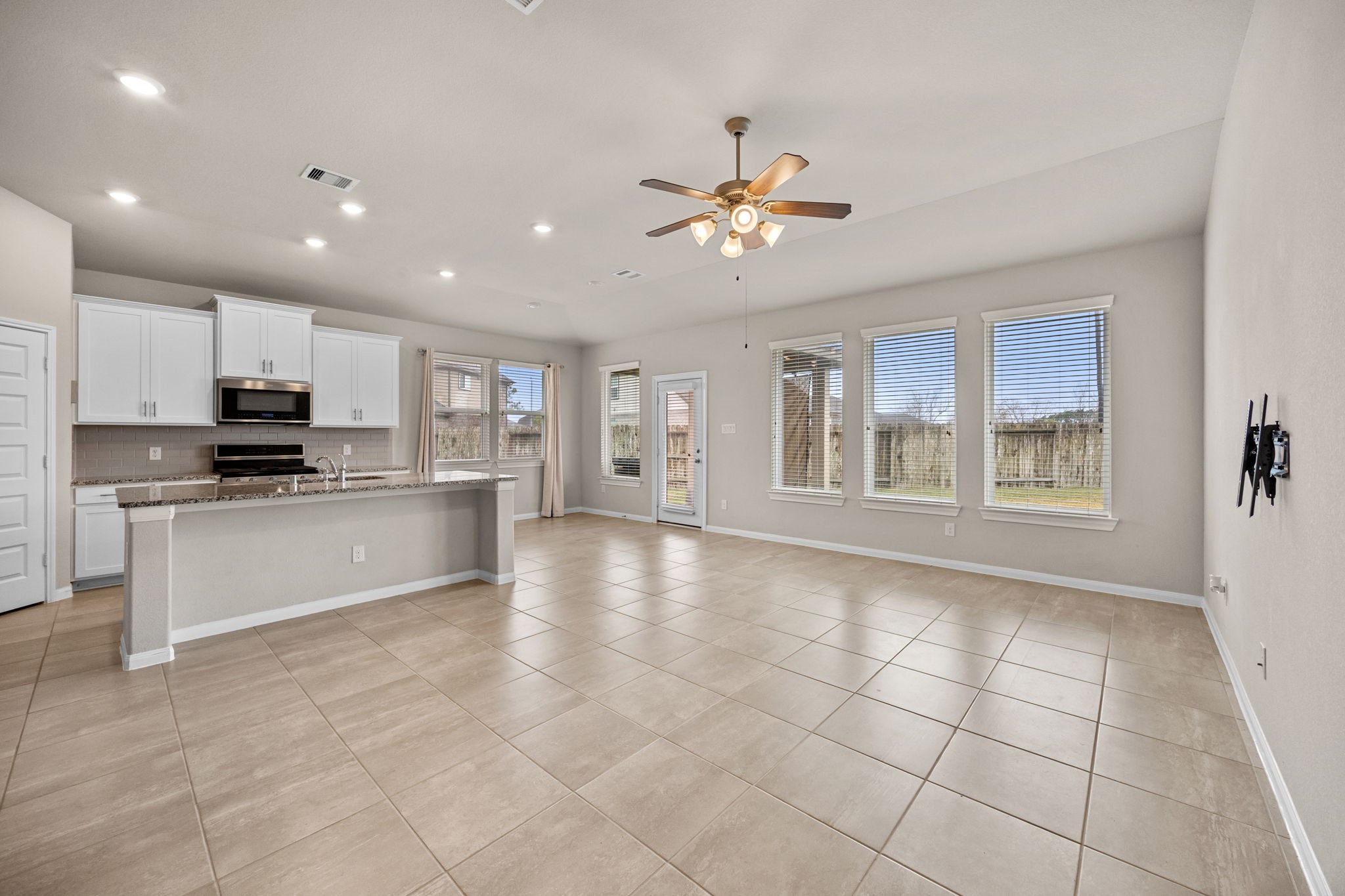 2406 Temple Crag Drive Rosharon, TX 77583 - Photo 6 of 26 The large family room is open to the kitchen creating a space that can easily meet the demands of a busy family. The room can easily accommodate a large seating area with plenty of room left over for entertainment equipment.
