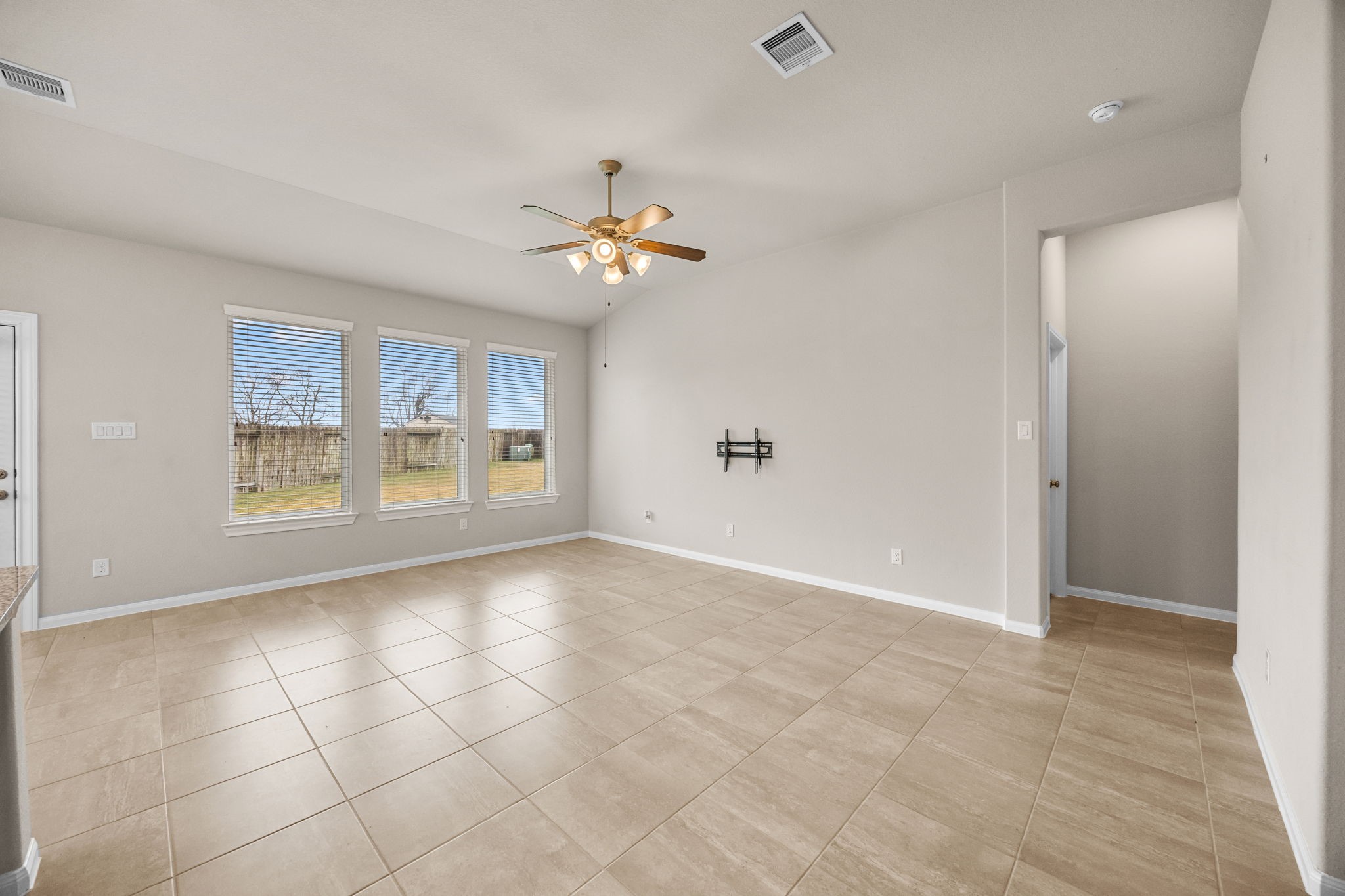 2406 Temple Crag Drive Rosharon, TX 77583 - Photo 7 of 26 Another view of the family room with the kitchen and breakfast area on the left. The family room's trio of windows offer views of the backyard. The door between the family room and the breakfast area opens to a nice covered patio and huge backyard!