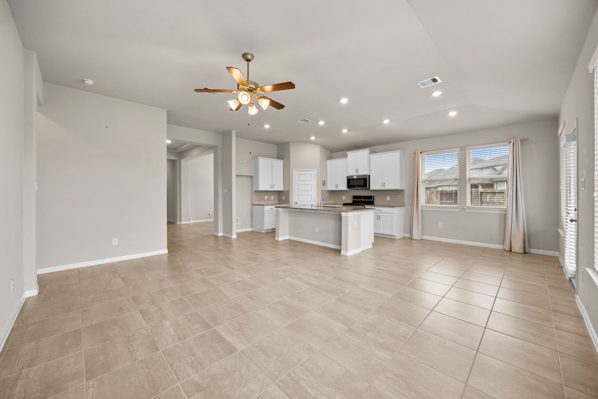 2406 Temple Crag Drive Rosharon, TX 77583 - Photo 8 of 26 A look back from the family room in to the main entry with the breakfast area, kitchen and the opening to the formal dining room on the right.