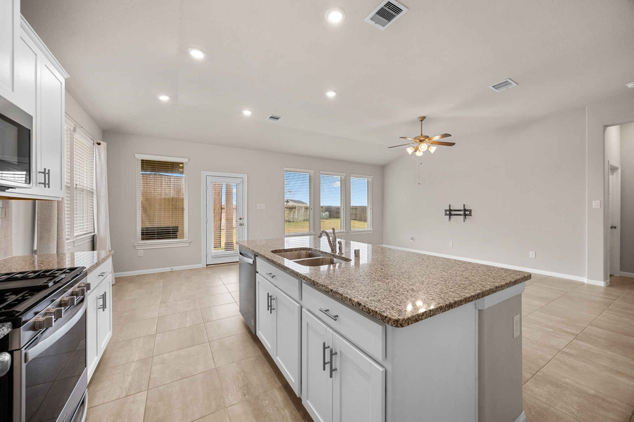 2406 Temple Crag Drive Rosharon, TX 77583 - Photo 10 of 26 Stainless steel appliances in the kitchen include a gas burner range, built-in microwave and dishwasher.