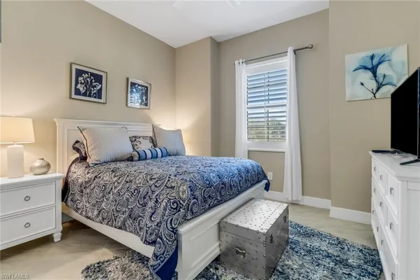 a bedroom with a bed and a television
