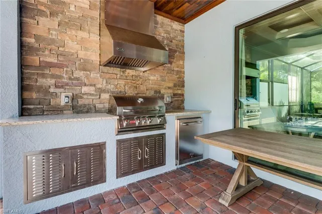 a kitchen with a stove a sink and a cabinets