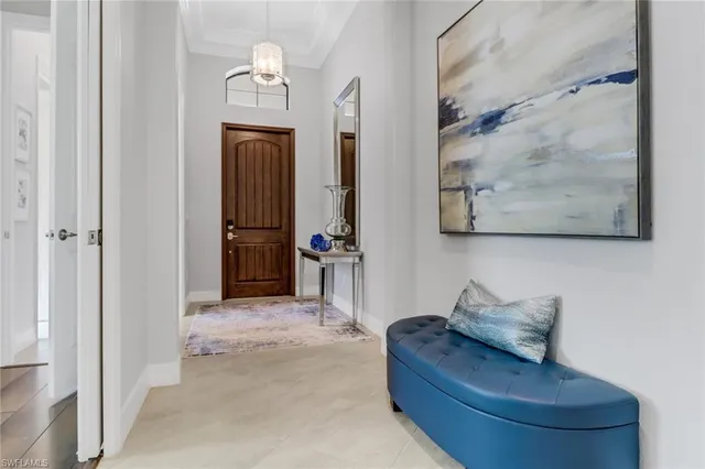 a living room with furniture and a mirror