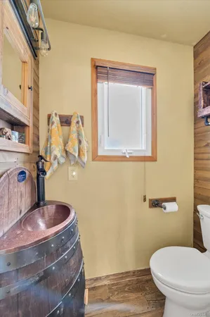 a bathroom with a toilet sink and mirror