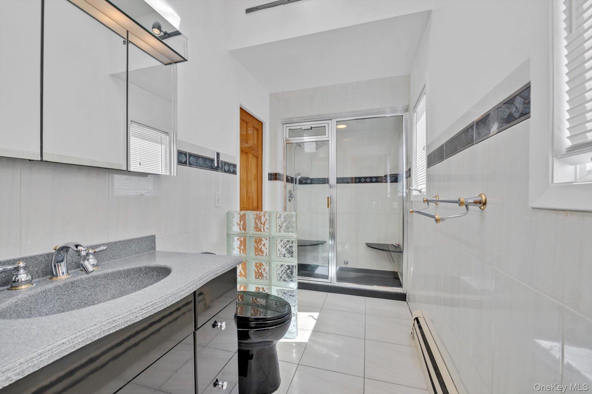 713 Hungry Harbor Road Valley Stream, NY 11581 - Photo 14 of 25 a bathroom with a sink and a mirror