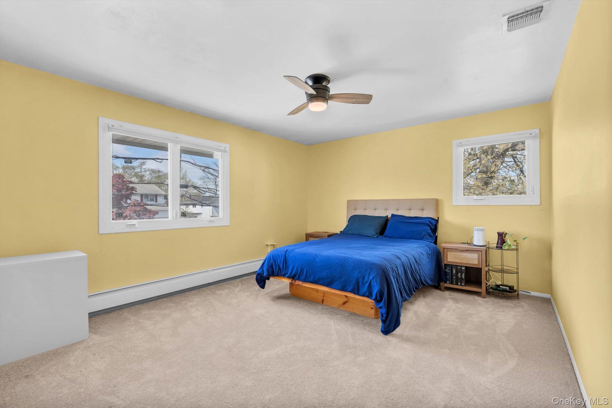 713 Hungry Harbor Road Valley Stream, NY 11581 - Photo 15 of 25 a bedroom with a bed and a ceiling fan