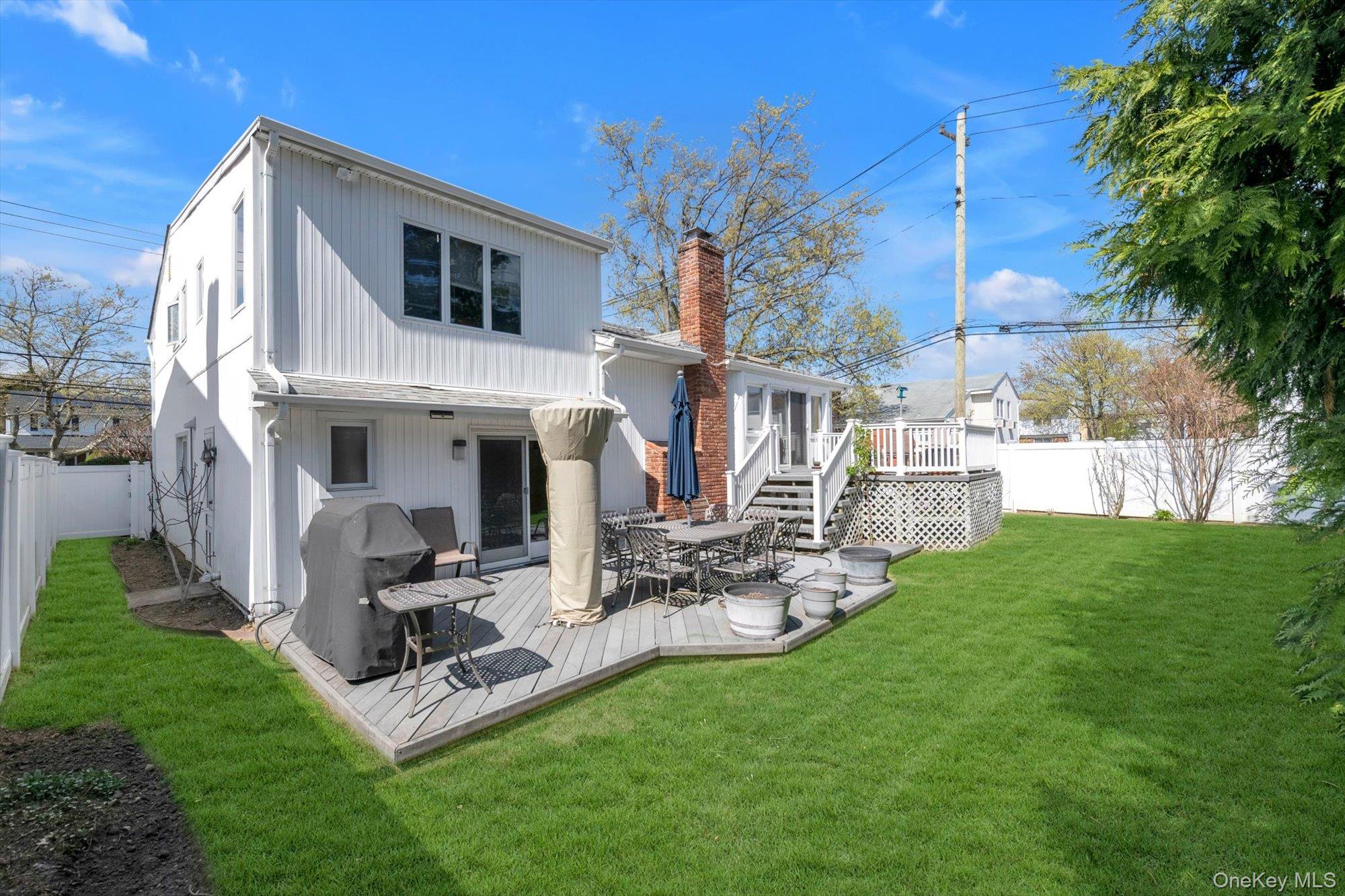 713 Hungry Harbor Road Valley Stream, NY 11581 - Photo 21 of 25 a view of a house with backyard porch and sitting area