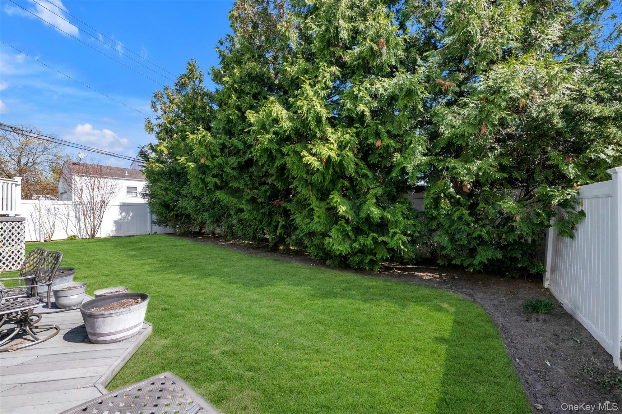 713 Hungry Harbor Road Valley Stream, NY 11581 - Photo 23 of 25 a view of a backyard with sitting area