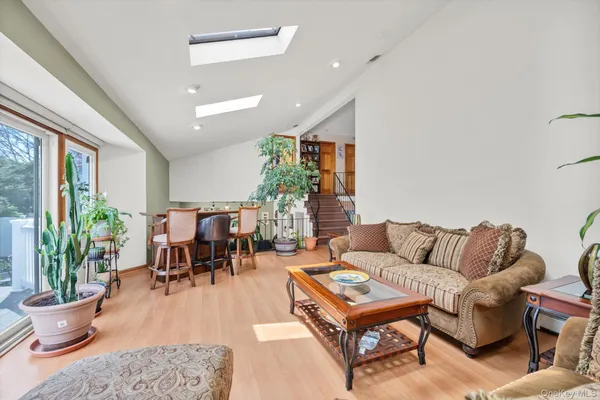 a living room with furniture and a potted plant
