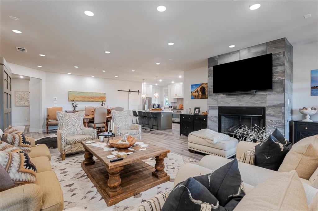 a living room with fireplace furniture and a flat screen tv