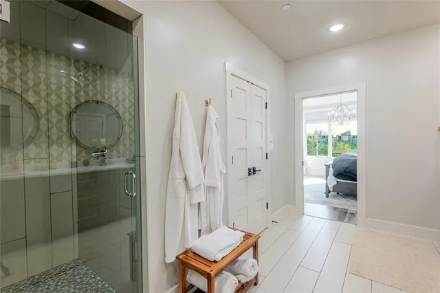 a bathroom with a shower a sink and a mirror