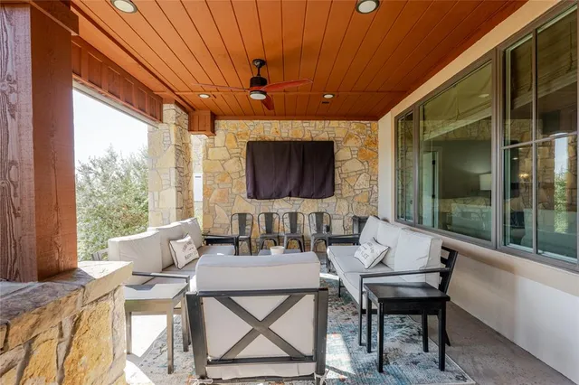 a dining room with furniture and a floor to ceiling window
