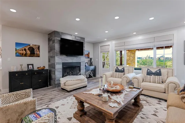 a living room with furniture flat screen tv and a fireplace