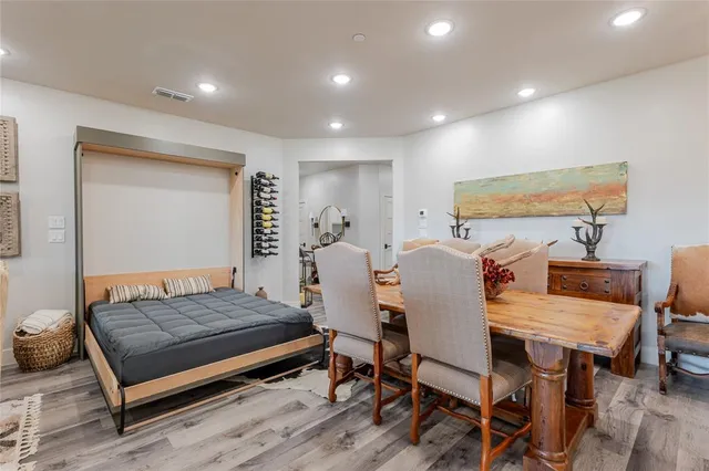 a bedroom with a bed a table and chair