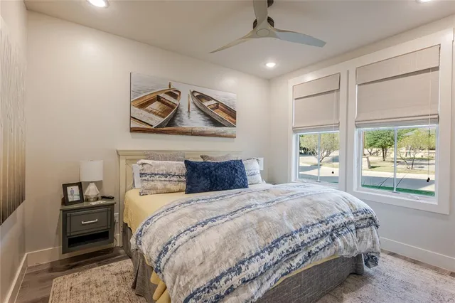 a bathroom with a toilet a sink a mirror and vanity