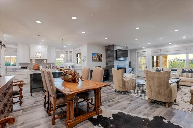 a dining room with kitchen island furniture a large window and kitchen view