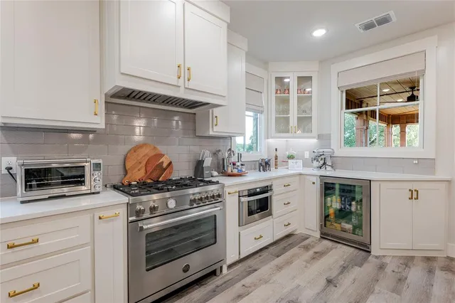 a kitchen with stainless steel appliances granite countertop a stove and a microwave