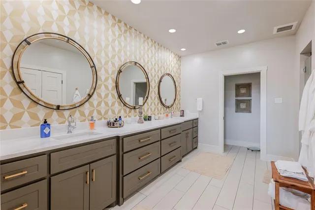a bathroom with a double vanity sink and a mirror