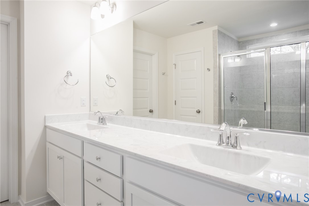 4830 Tuscany Road Moseley, VA 23120 - Photo 14 of 23 a bathroom with double vanity sinks and a bathtub
