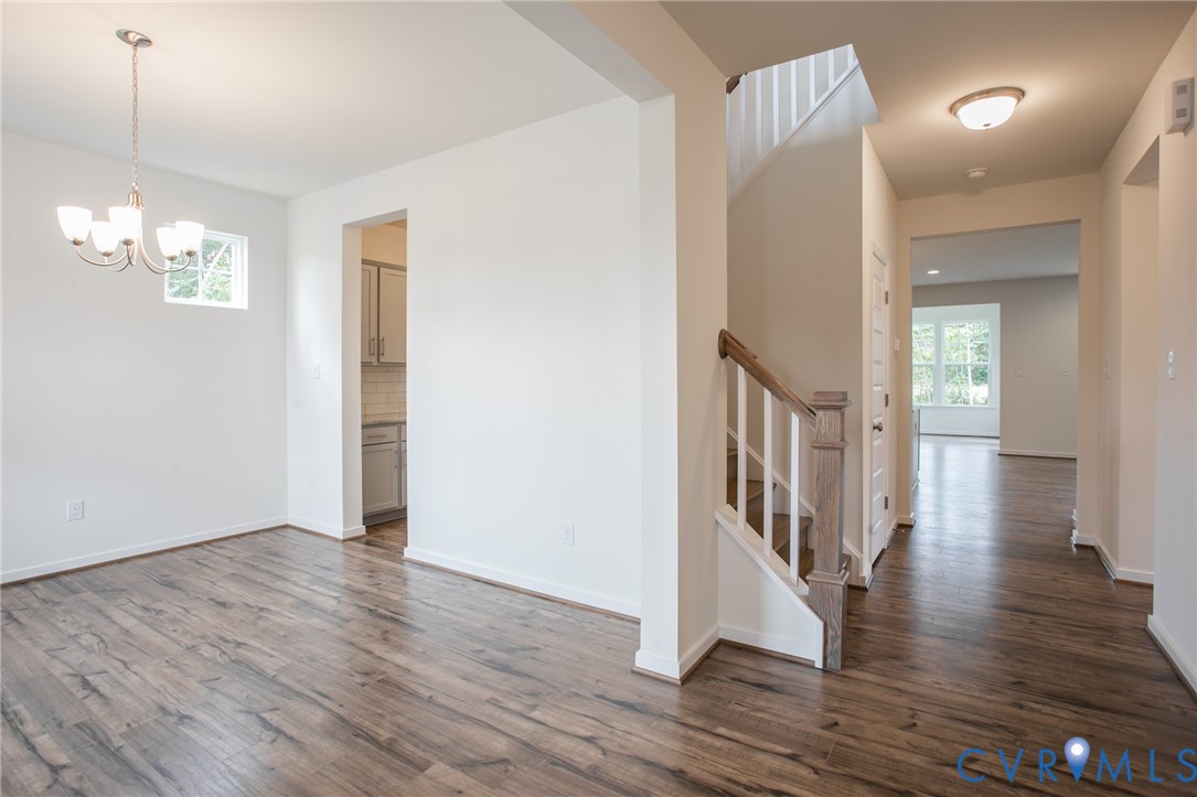 4830 Tuscany Road Moseley, VA 23120 - Photo 5 of 23 a view of a hallway with wooden floor and staircase