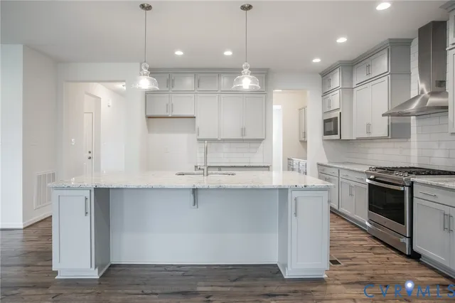 a large kitchen with stainless steel appliances lots of counter space sink and cabinets