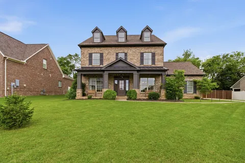 a front view of a house with a garden and porch