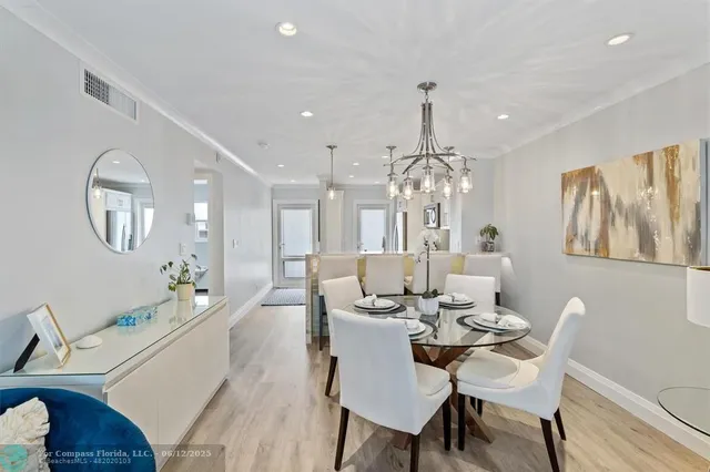 a bathroom with a granite countertop sink a toilet a mirror and shower