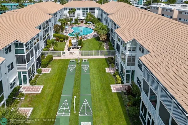 a view of a cafe with a table and chairs under an umbrella