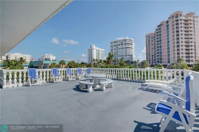 a terrace with outdoor seating and city view