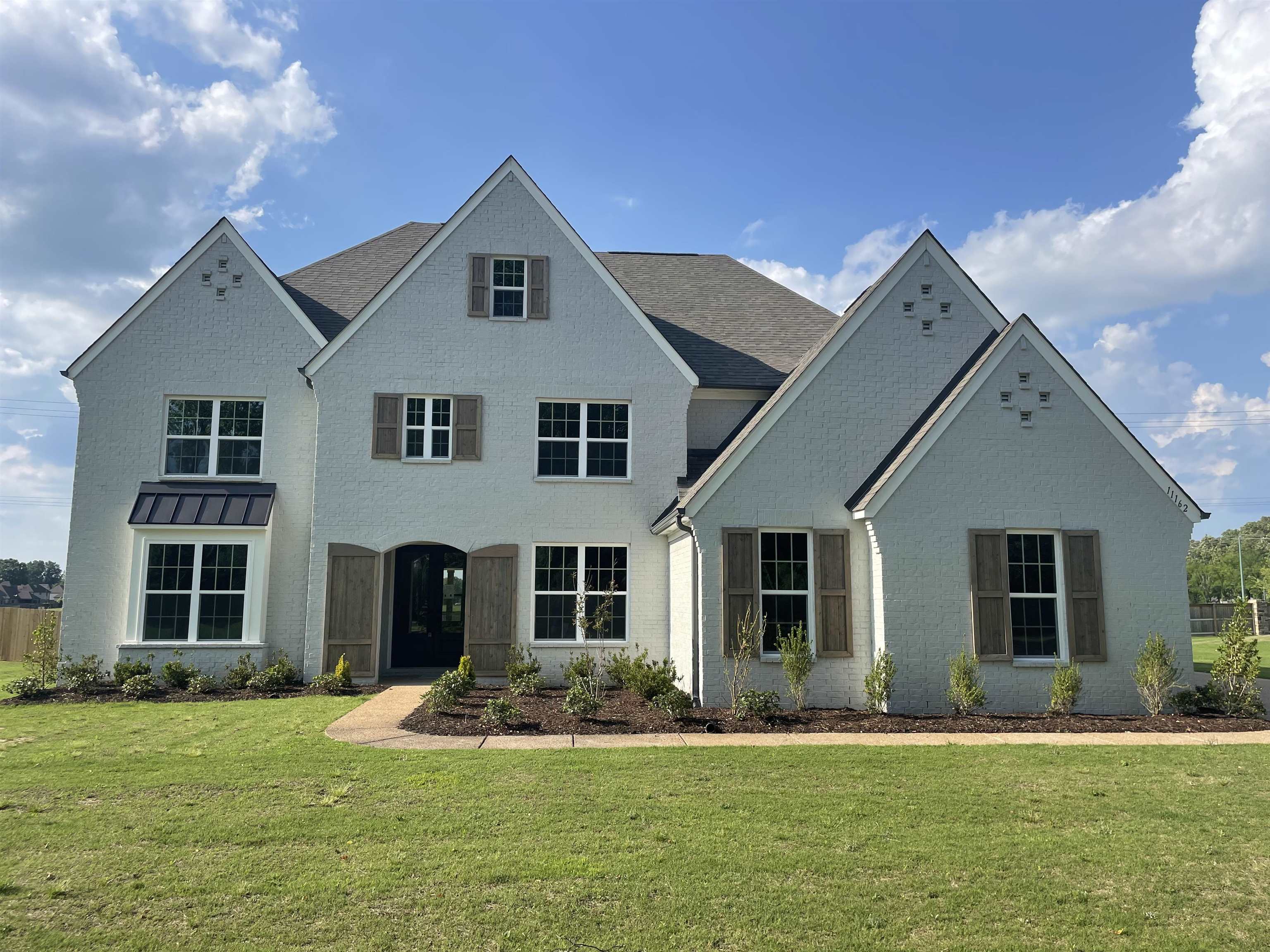 a front view of a house with a yard