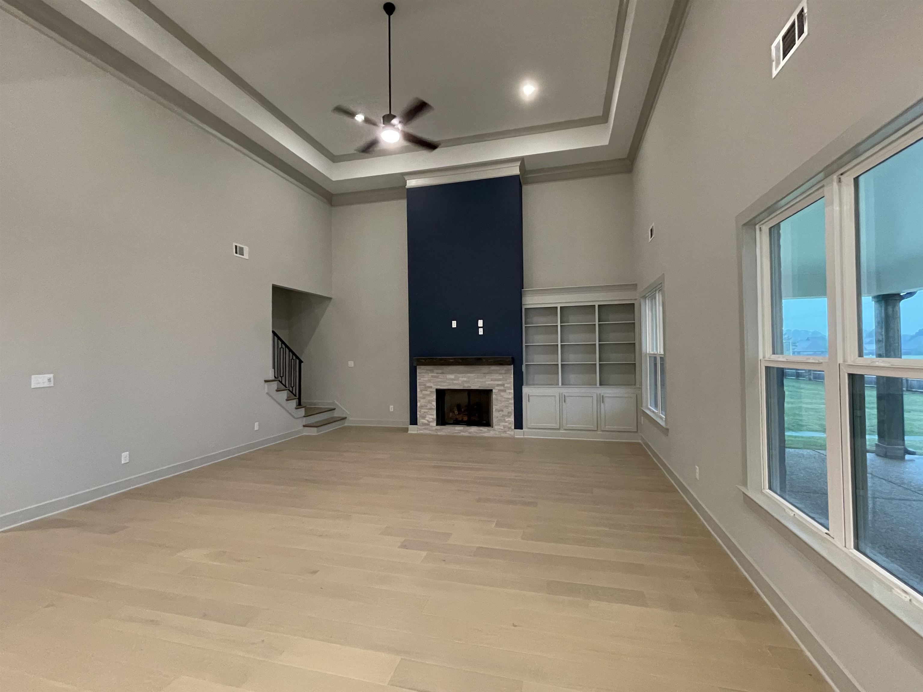11162 Shelby Post Road Collierville, TN 38017 - Photo 4 of 23 a view of an empty room with a fireplace and a window