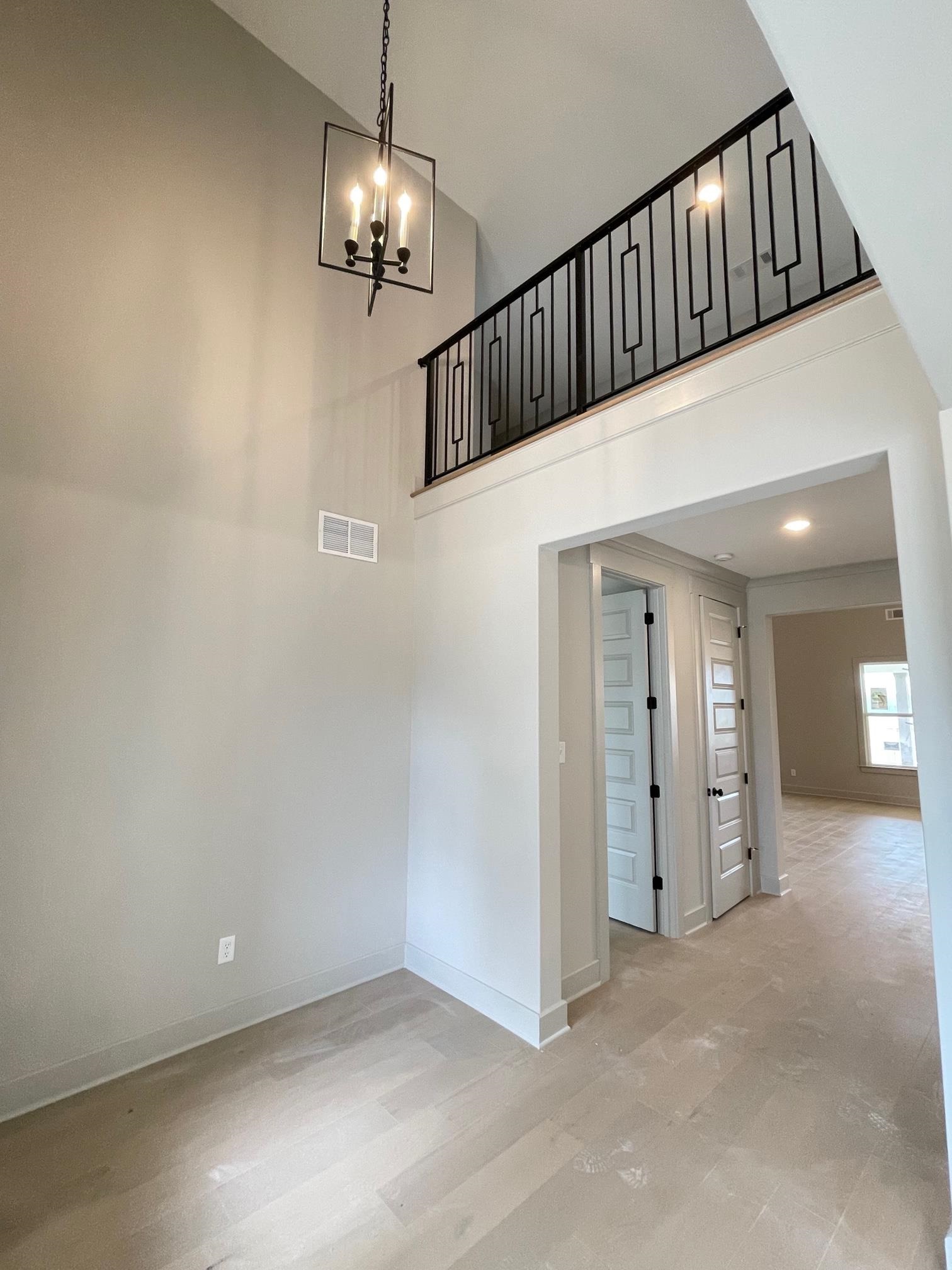 11162 Shelby Post Road Collierville, TN 38017 - Photo 5 of 23 en empty room with stairs and a chandelier fan