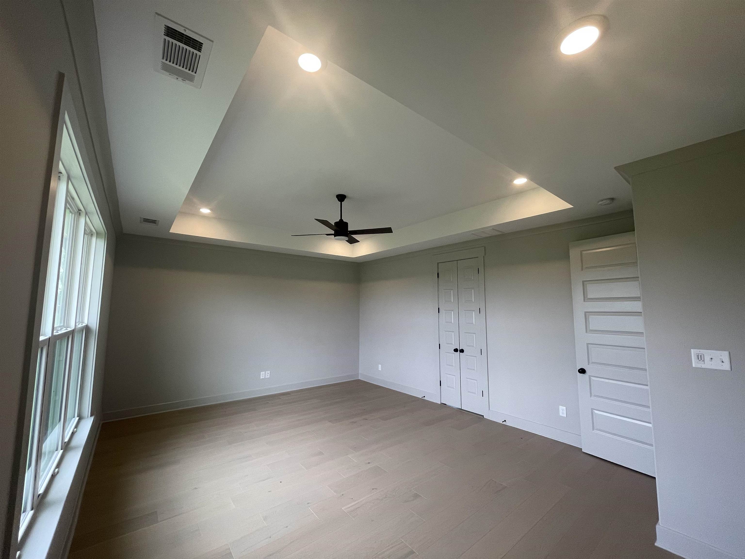 11162 Shelby Post Road Collierville, TN 38017 - Photo 8 of 23 an empty room with a ceiling fan and windows