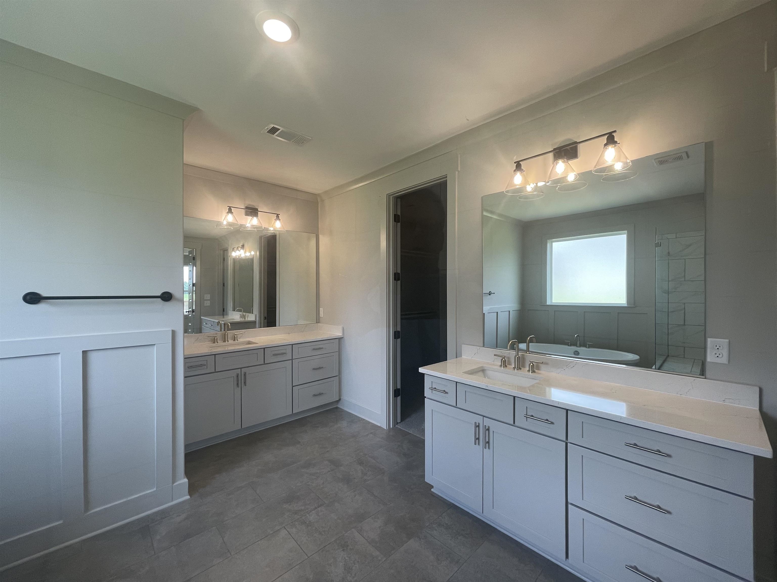 11162 Shelby Post Road Collierville, TN 38017 - Photo 9 of 23 a bathroom with double vanity sink a bathtub and a mirror
