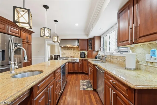 a kitchen with granite countertop a sink stove and cabinets
