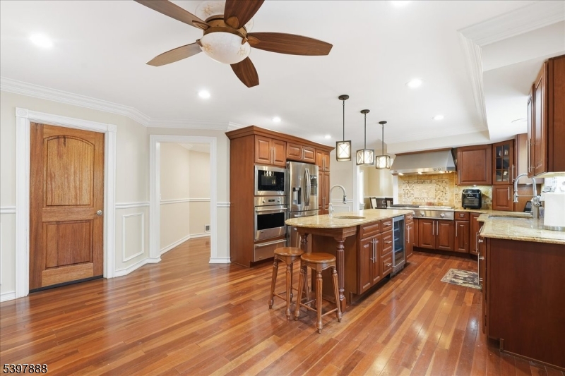 1605 Justin Place, Unit 1 Mountainside, NJ 07092 - Photo 12 of 43 a large kitchen with cabinets wooden floor and stainless steel appliances