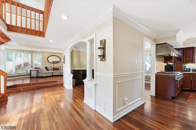 a view of a living room and kitchen with furniture wooden floor and kitchen