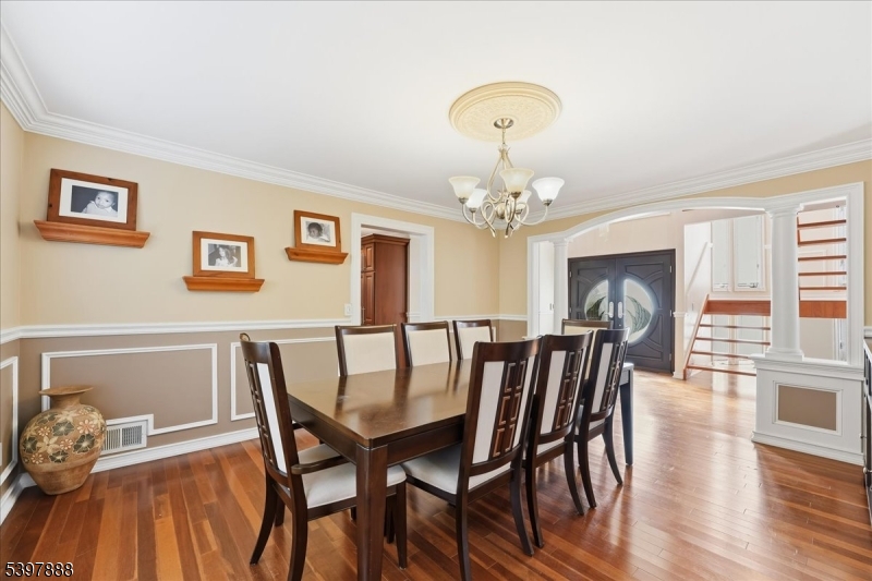 1605 Justin Place, Unit 1 Mountainside, NJ 07092 - Photo 18 of 43 a view of a dining room with furniture a chandelier and wooden floor