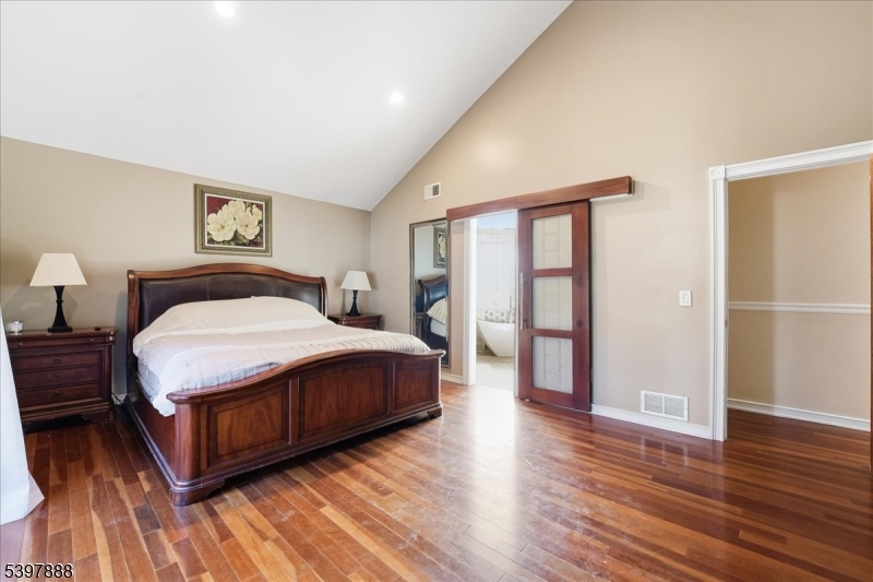 1605 Justin Place, Unit 1 Mountainside, NJ 07092 - Photo 34 of 43 a spacious bedroom with a bed and wooden floor