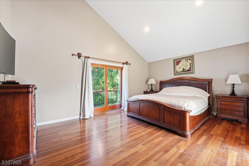 1605 Justin Place, Unit 1 Mountainside, NJ 07092 - Photo 35 of 43 a spacious bedroom with a bed and wooden floor